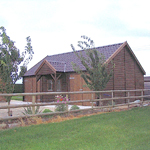 Double garage with canopy and steel tile effect roof.