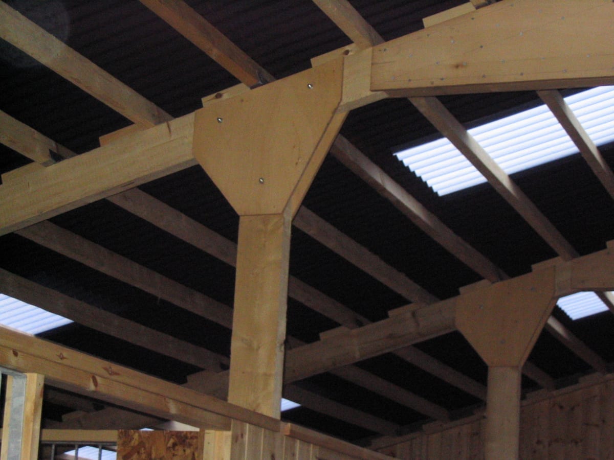 Inside an American barn: timber posts, roof trusses and roof lights