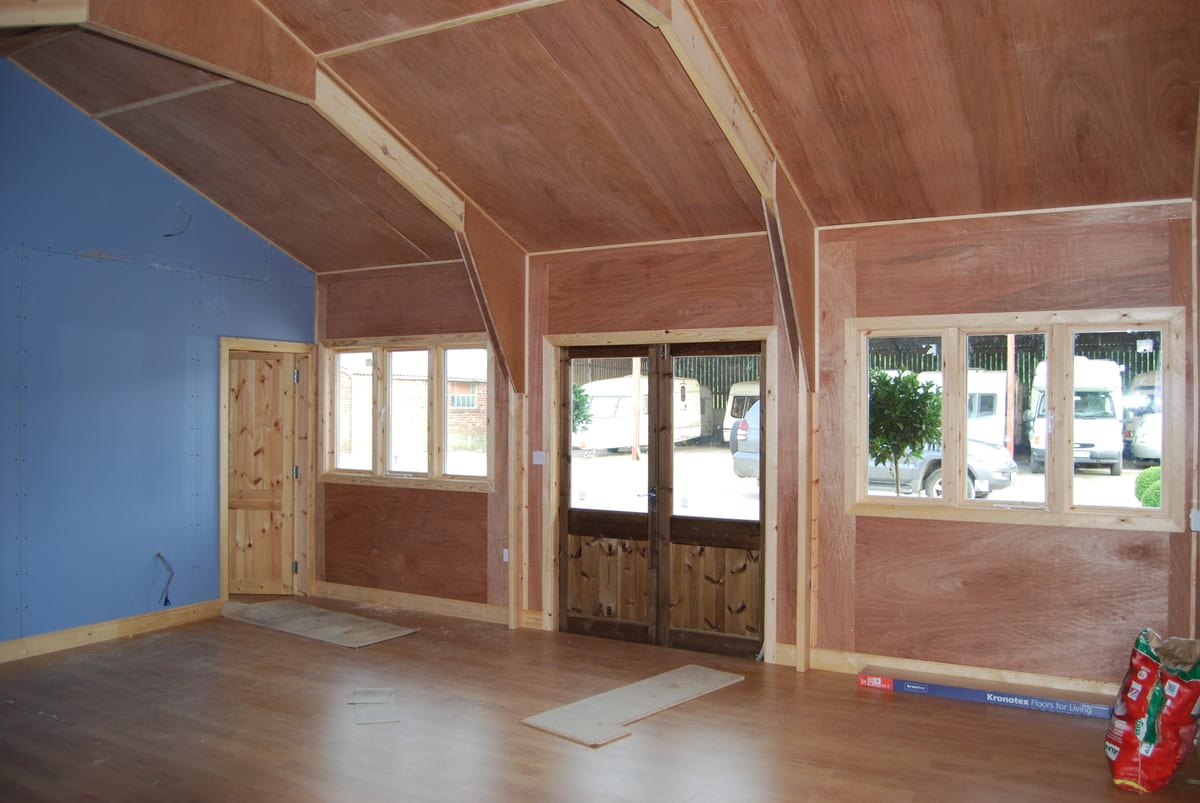 Inside a timber showroom and office, with lined walls and ceiling