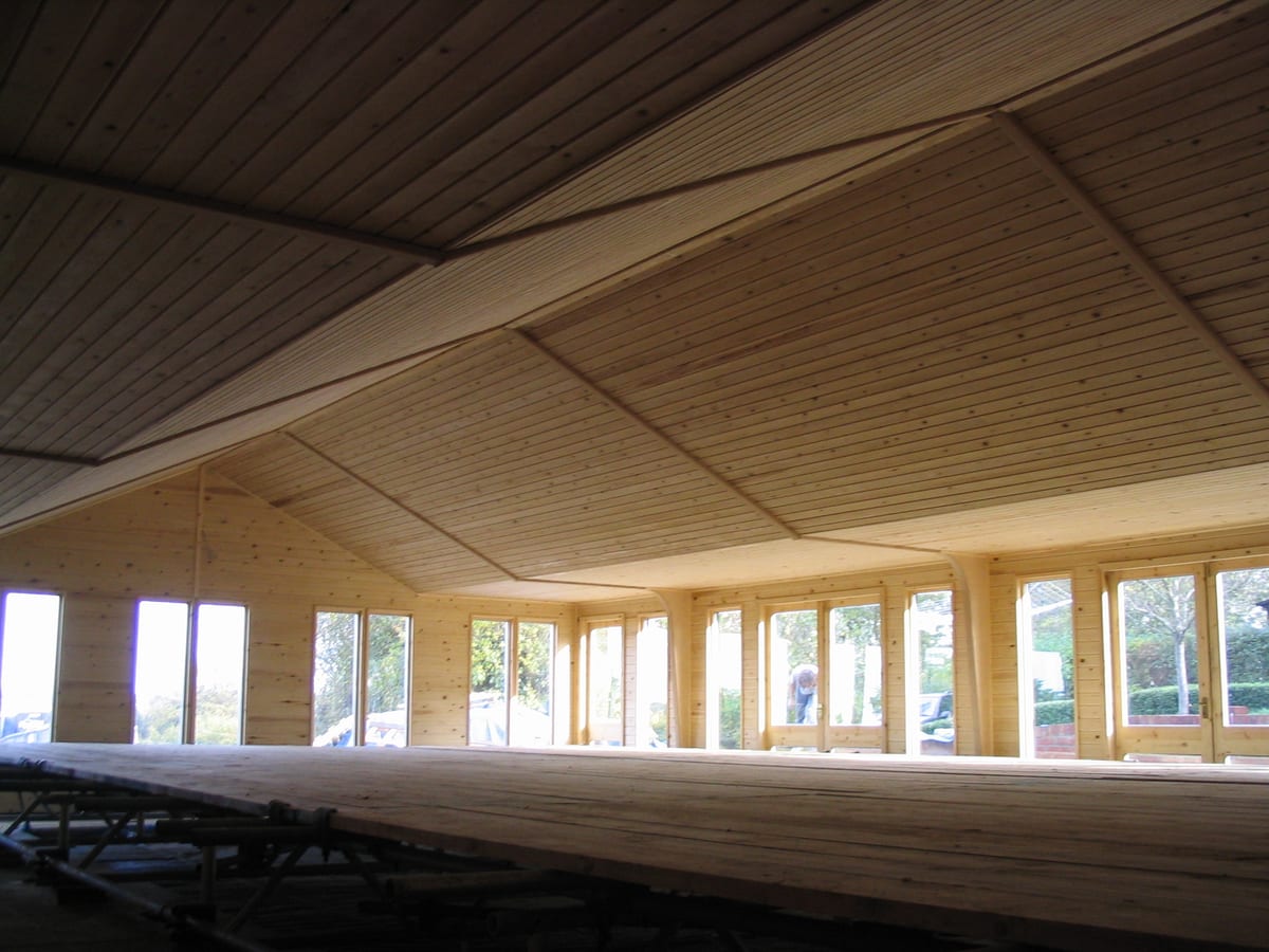 Inside a timber pool enclosure, with lined walls and ceiling
